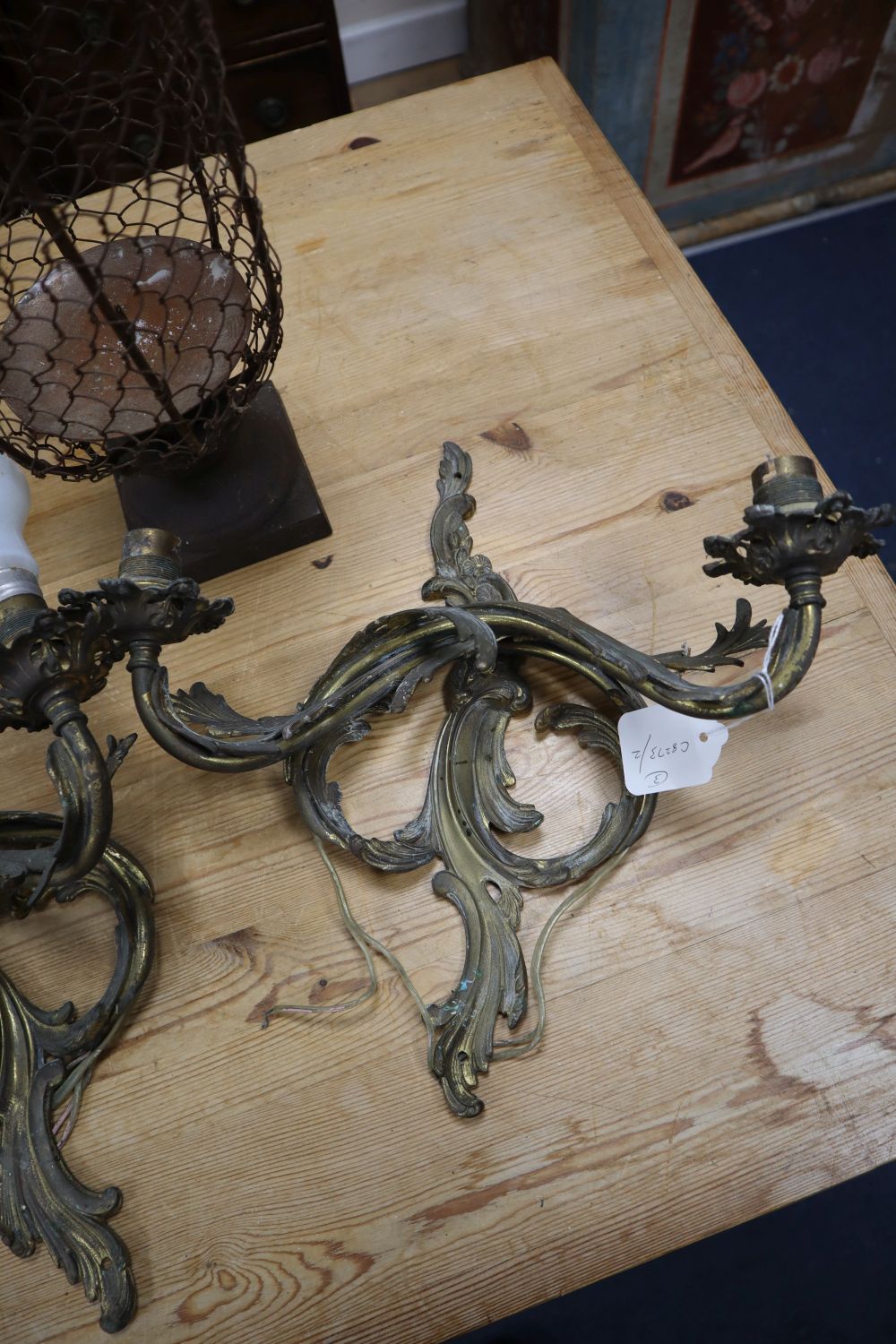 A pair of Louis XV style gilt metal two branch wall lights, and a metal wire framed pricket candle holder, 33cm
